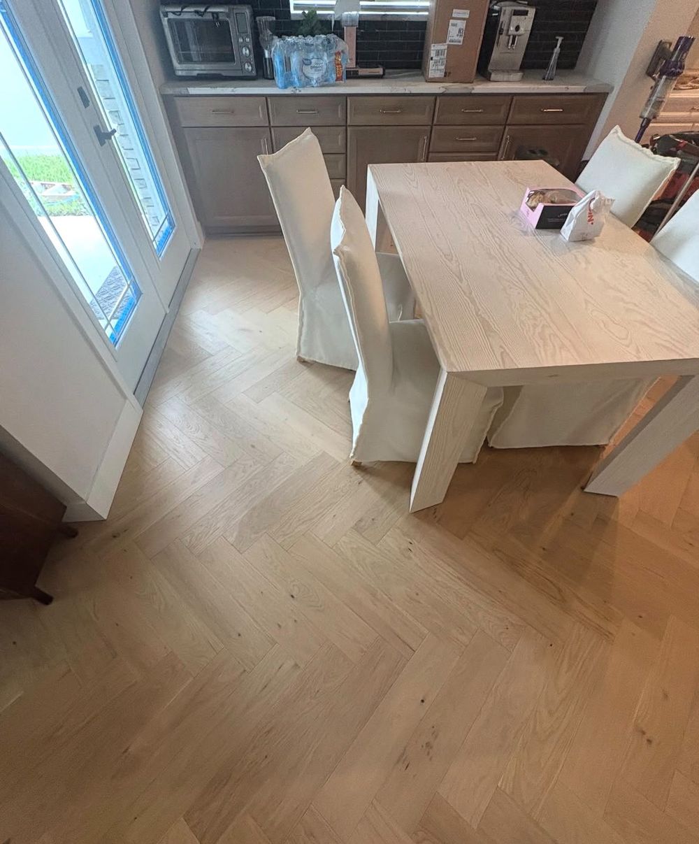Light oak herringbone hardwood floor in a dining area