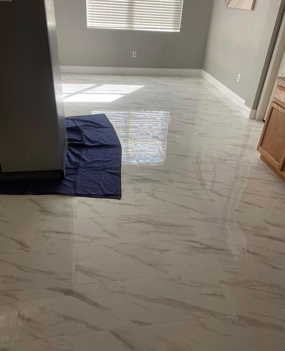 Polished marble-look tile floor installed in a Tampa Bay home
